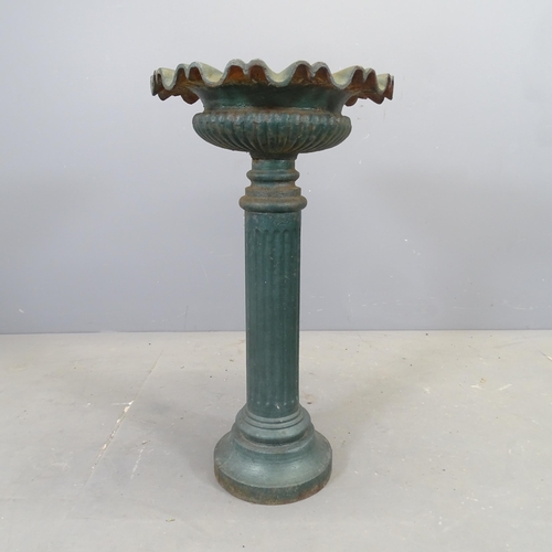 3104 - A French painted cast iron urn on stand, with fluted decoration. 42x77cm.