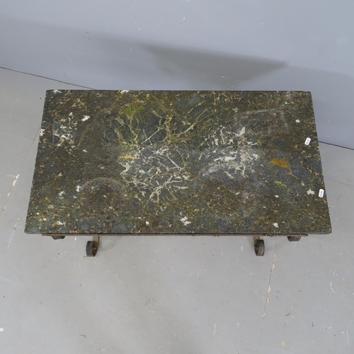 3110 - A weathered stone topped garden table on wrought iron base. 86x56x47cm.