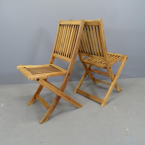 3113 - A set of four teak slatted folding garden chairs.