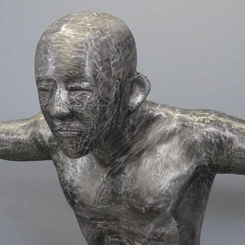 3120 - After Marco Olivier - A brushed aluminium sculpture, study of a naked man with outstretched arms. He... 