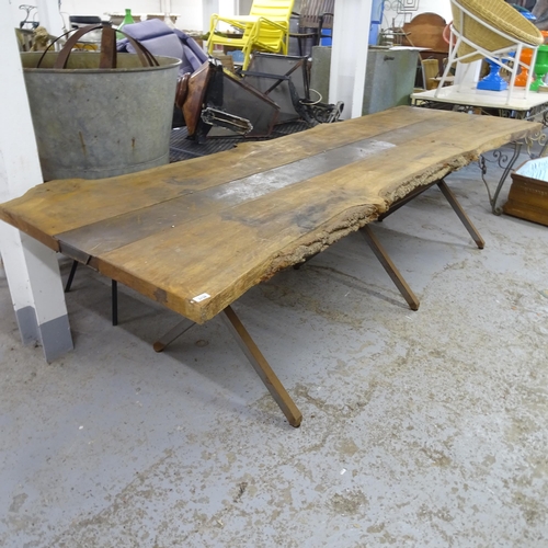 3138 - A large and impressive oak-topped live edge table on steel base. 300x80x110cm.