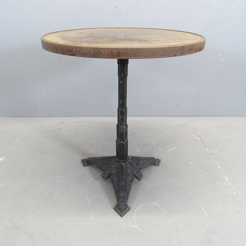 3145 - LOUIS VUITTON - A French Art Deco bistro table with circular Bakelite top on gilt painted cast iron ... 