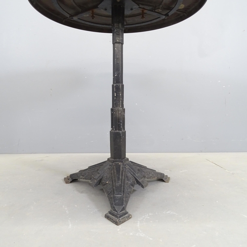 3145 - LOUIS VUITTON - A French Art Deco bistro table with circular Bakelite top on gilt painted cast iron ... 