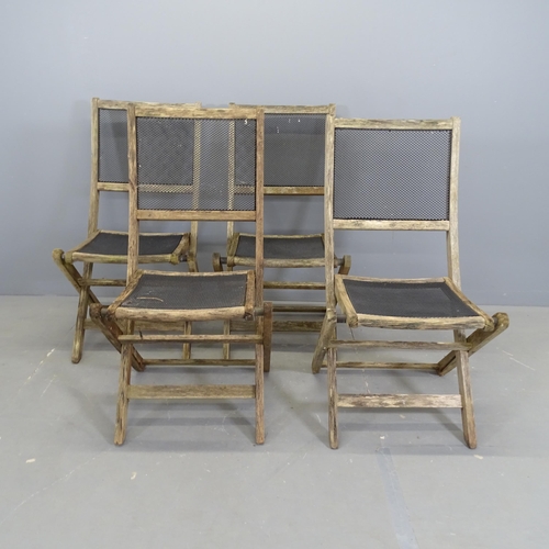 3151 - A set of four weathered teak folding garden chairs, with mesh panelled seats and backs.