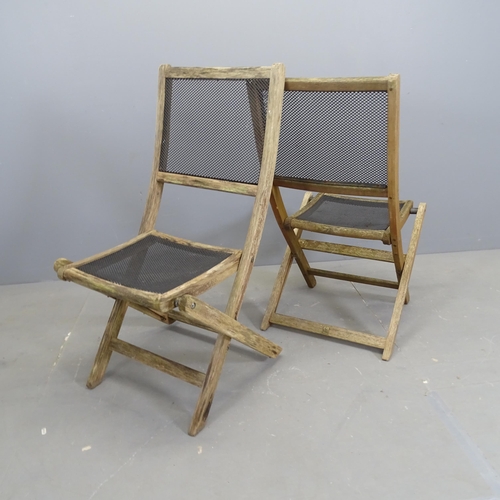 3151 - A set of four weathered teak folding garden chairs, with mesh panelled seats and backs.