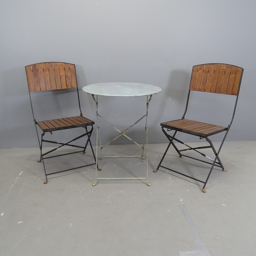 3162 - A modern circular folding painted metal garden table, 60x71cm, and two folding chairs.