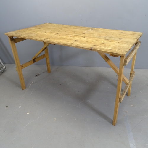 3174 - A vintage pine folding plank top trestle table. 128x76x67cm.