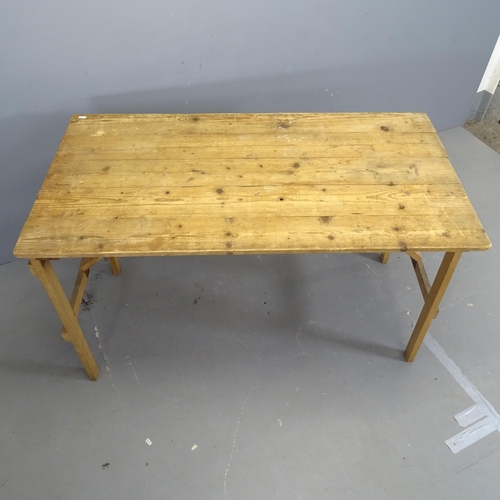 3174 - A vintage pine folding plank top trestle table. 128x76x67cm.