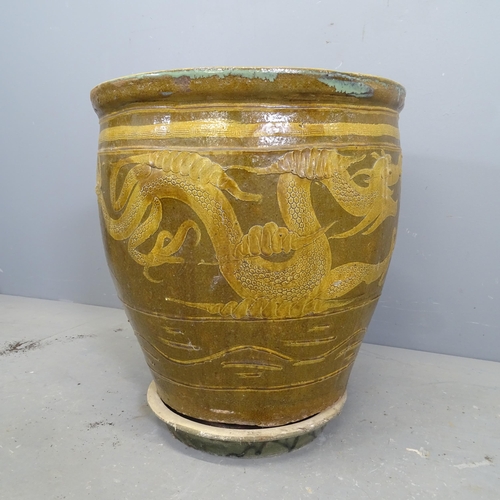 3175 - A large glazed ceramic plant pot, with Chinese dragon design and matching drip tray. 49x52cm.