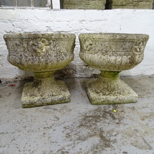 3192 - A pair of weathered concrete two-section garden urns. 37x37x37cm.