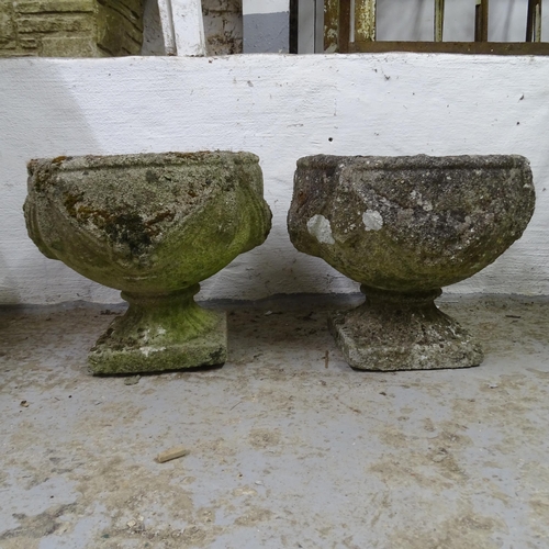 3195 - A pair of weathered concrete garden urns, with swag decoration. 38x32cm.