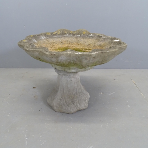 3200 - A weathered concrete two-section shell design bird bath. 54x43cm.