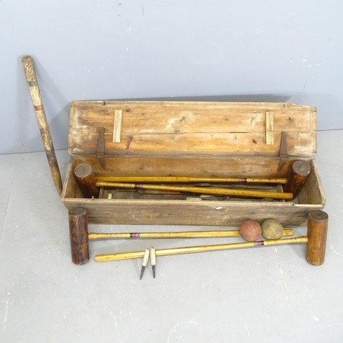 3205 - A vintage croquet set in pine case. 108x26x24cm.