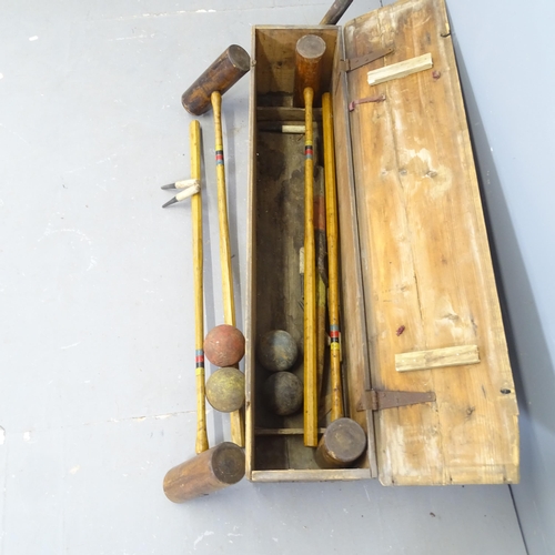 3205 - A vintage croquet set in pine case. 108x26x24cm.