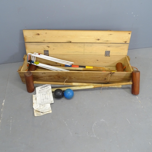 3211 - A vintage croquet set in pine case. 110x20x27cm.