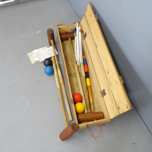 3211 - A vintage croquet set in pine case. 110x20x27cm.