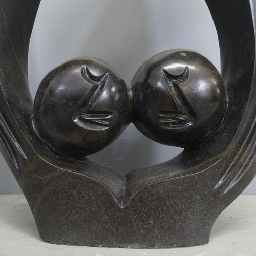 3215 - A large handstone sculpture, abstract study of two heads in stone. Height 90cm.