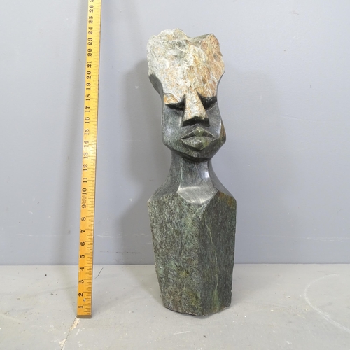 3217 - A handcarved green hardstone sculpture, study of a head in the African style. Height 60cm.