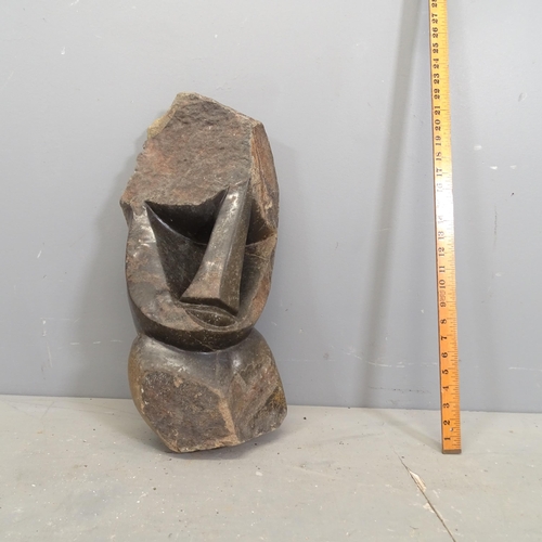 3218 - A hand carved hardstone sculpture, study of a head in the African style. Height 59cm.