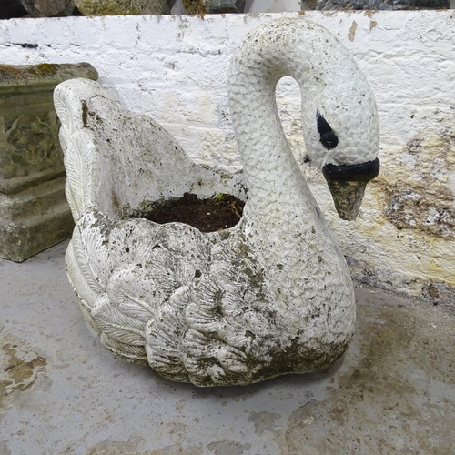 3227 - A painted cast reconstituted stone planter in the form of a swan. 58x50x44cm.