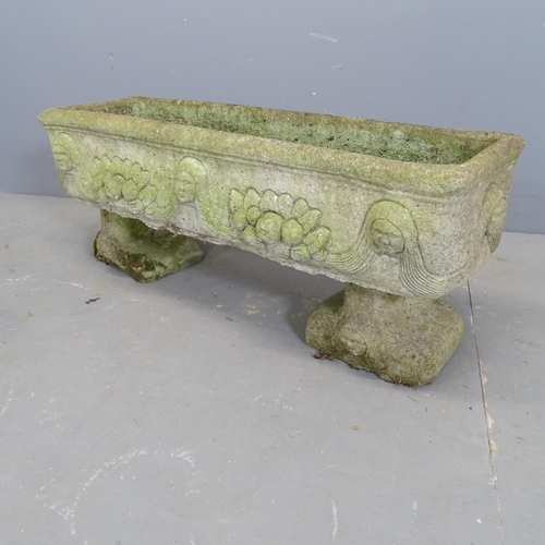 3249 - A weathered concrete rectangular garden planter, raised on two feet, with figural and floral decorat... 