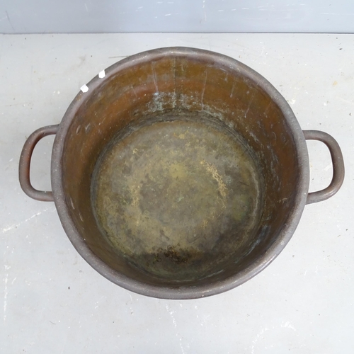 3251 - A large two handled copper bowl. 61x36x49cm.