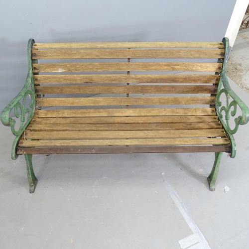 3259 - A teak slatted garden bench with painted cast iron ends. 128x78x68cm.