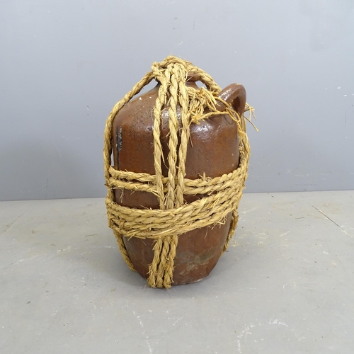 3260 - A rope bound glazed oil or water flagon. H - 57cm.