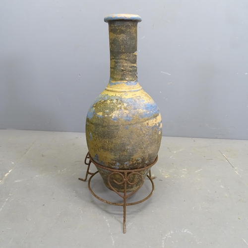 3261 - A vintage blue painted terracotta vase on wrought iron stand. H - 76cm.