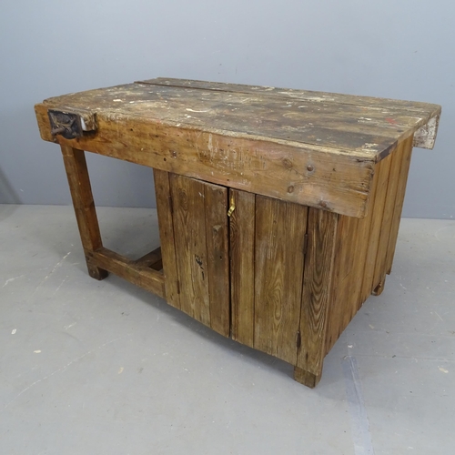 3269 - A vintage stained pine workbench, with Whitmore vice and cupboards under. 123x73x70cm.