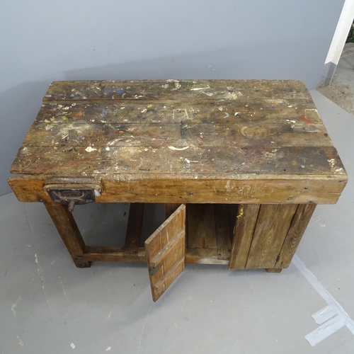 3269 - A vintage stained pine workbench, with Whitmore vice and cupboards under. 123x73x70cm.