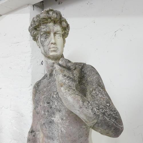 3276 - A weathered stone garden sculpture, after Michelangelo's David. Height 120cm.