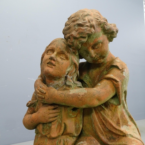 3280 - A painted concrete garden statue, two lovers embracing. Height 60cm.