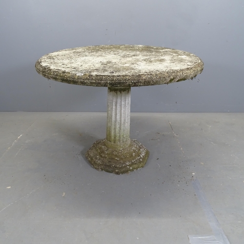 3293 - A weathered concrete circular topped garden table on Corinthian column base. 90x64cm.