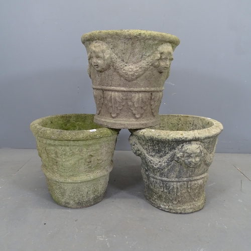 3318 - A set of three weathered concrete garden planters with moulded figural and swag decoration. 39x34cm.