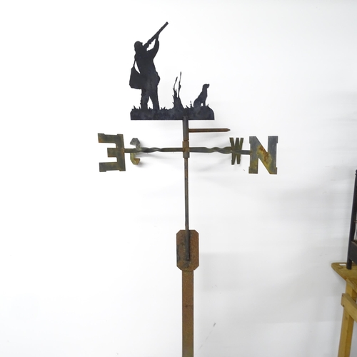 3331 - A vintage iron weather vane, depicting hunter with hound. 62x148cm.