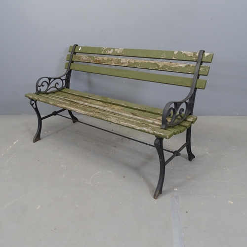 3336 - A teak slatted garden bench with cast iron ends. 120x70x44cm.