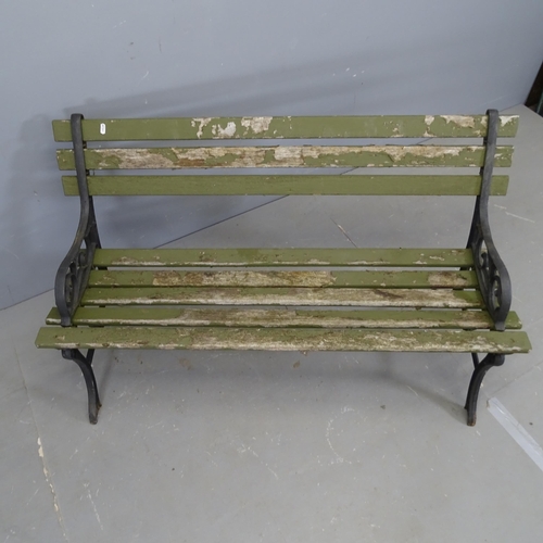 3336 - A teak slatted garden bench with cast iron ends. 120x70x44cm.