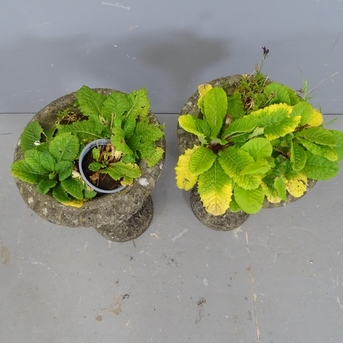 3349 - A pair of small weathered concrete fluted urns on stands. 33x45cm.