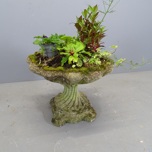 3353 - A weathered concrete two-section shell design planter on stand. 54x48cm.