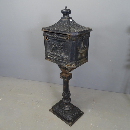 3368 - A painted cast iron letterbox. 42x113x29cm. Lacking lock.