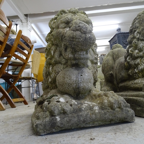 3387 - A pair of weathered stone recumbant lion sculptures. 63x42x29cm.