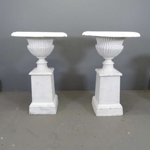 3396 - A pair of antique two section painted cast iron Campana style urns on stands, with reeded decoration... 