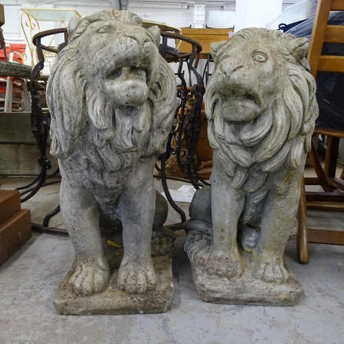 3399 - A pair of moulded stone lion statues. Height 64cm.