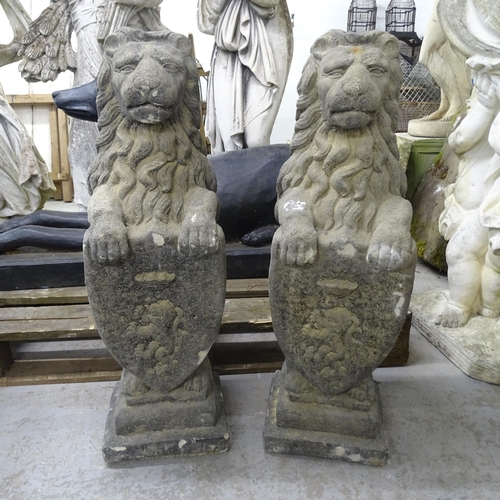 3401 - A pair of weathered concrete heraldric lion garden statues. Height 80cm.