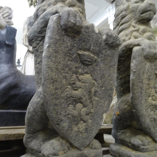 3401 - A pair of weathered concrete heraldric lion garden statues. Height 80cm.