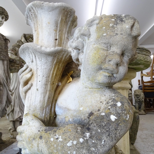 3406 - A weathered concrete garden statue, study of a cherub holding a cornucopia. Height 79cm.