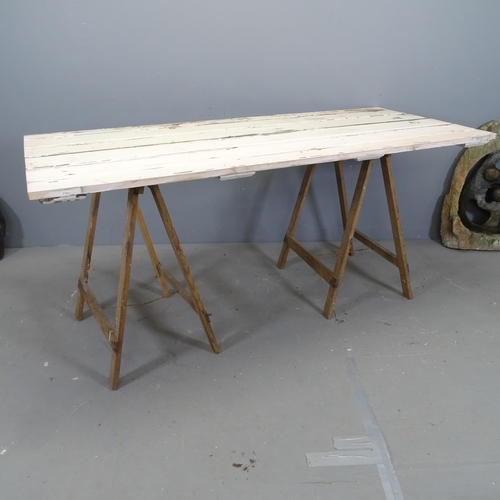 3413 - A vintage pine trestle table, repurposed from an old door. 169x77x76cm.