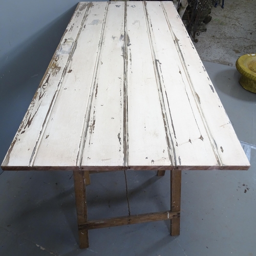 3413 - A vintage pine trestle table, repurposed from an old door. 169x77x76cm.