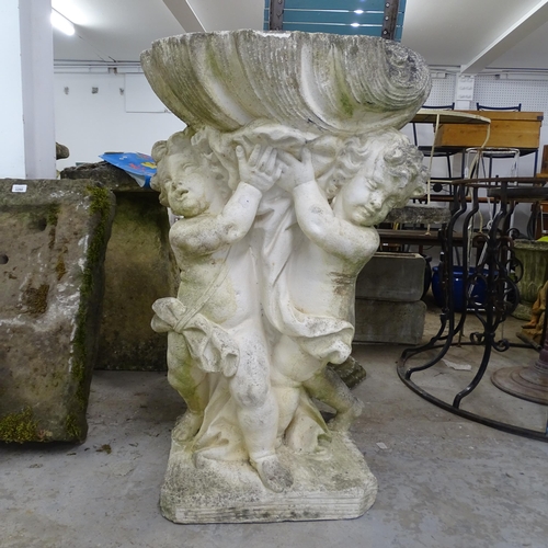 3421 - A weathered stone garden water feature, in the form of two cherubs supporting a shell. 62x100x53cm.